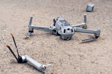 the-fall-of-the-drone-a-broken-flying-quadcopter-is-lying-on-the-asphalt-the-propeller-has-flown-off-and-the-camera-is-damaged-2G5HPAA